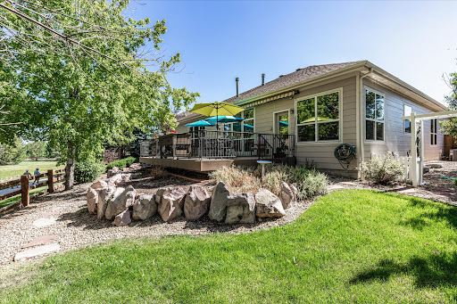 A beautiful backyard featuring a spacious deck and lush green lawn, perfect for outdoor gatherings.