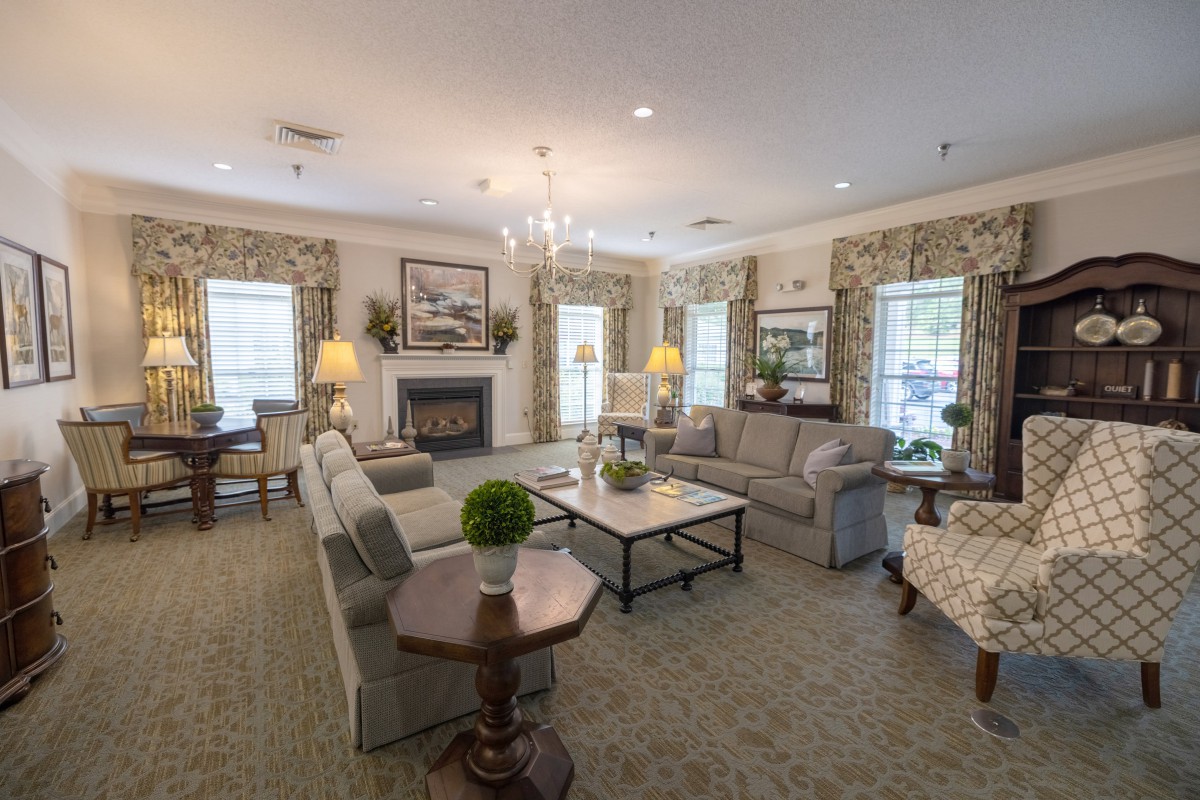 A well-furnished living room with sofas, a fireplace, and elegant decor.