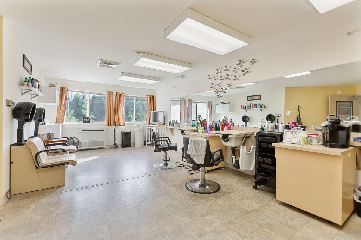 A spacious and well-lit hair salon with multiple styling stations.
