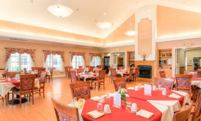 Elegant dining room with neatly arranged tables and warm decor.