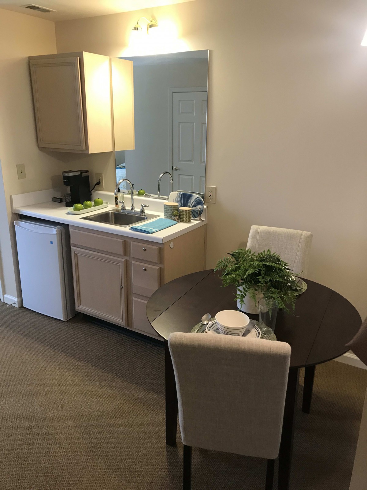 Cozy kitchen area with a small dining table and chairs.