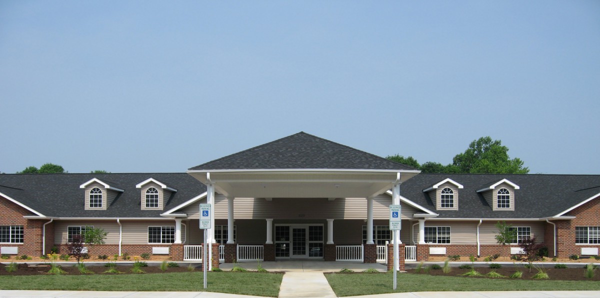 A modern building with a prominent entrance and covered porch.