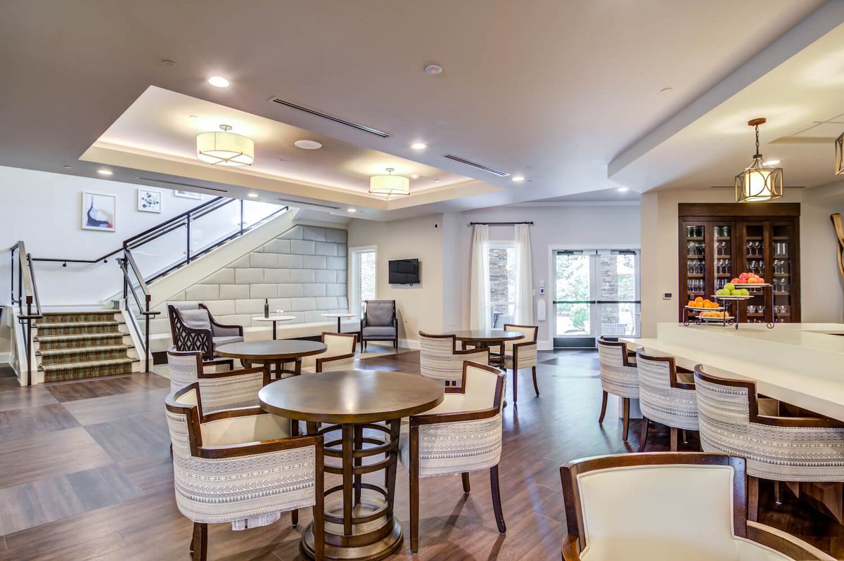 A modern lounge area with comfortable seating and a staircase.