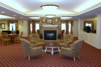 A cozy living room with a fireplace surrounded by comfortable seating.
