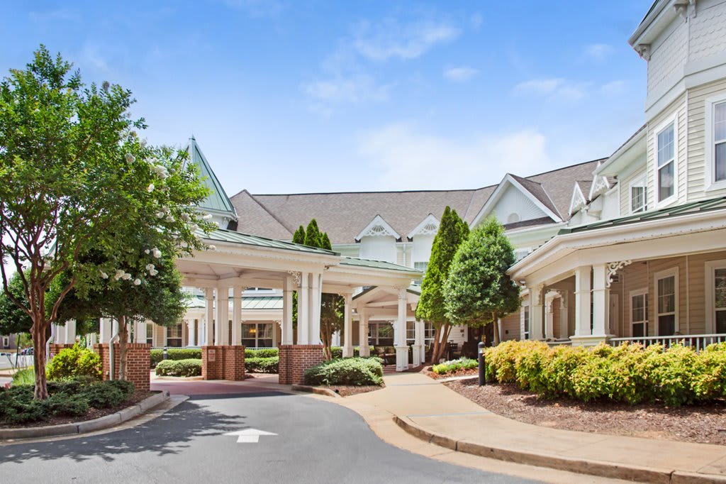 A suburban building with a landscaped entrance and circular driveway.