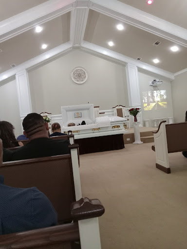 A view of the interior of a church with attendees seated.