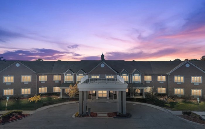 A hotel building at sunset with a clear sky.