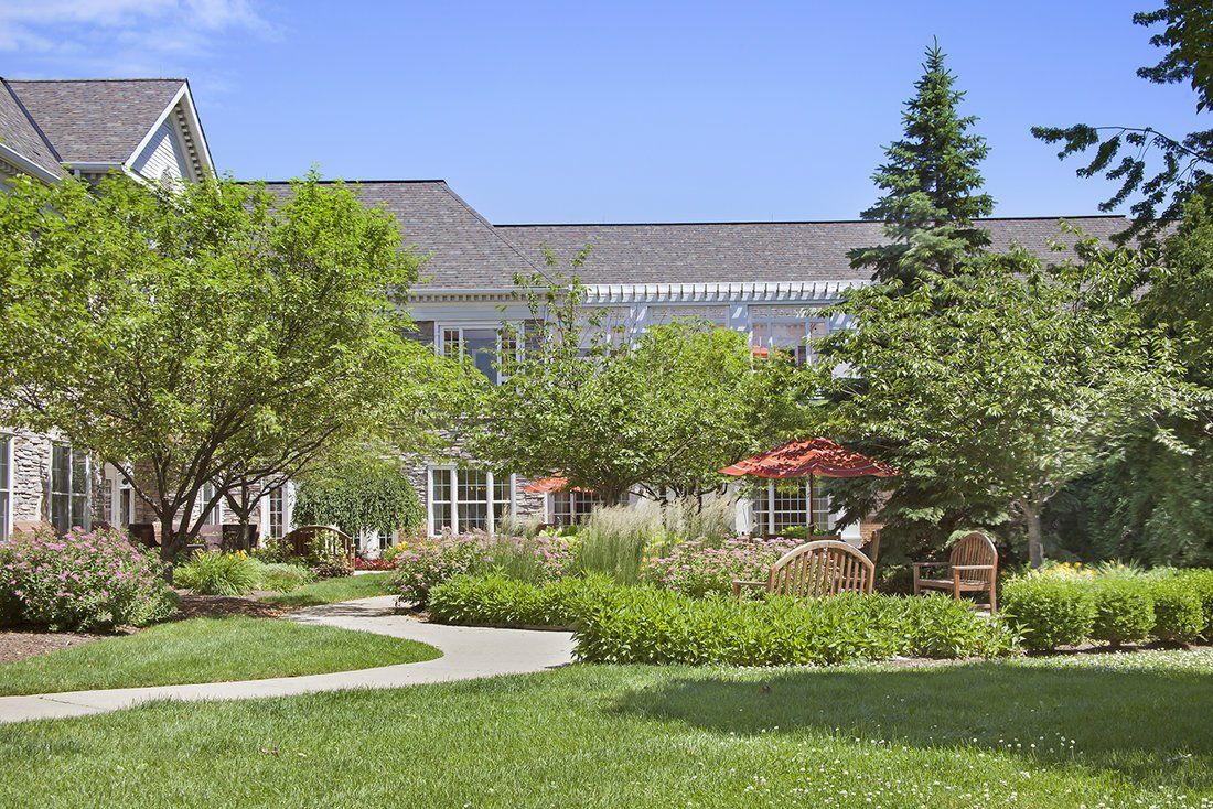 A beautiful residential house surrounded by a well-maintained garden and lush greenery.