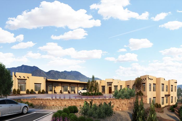 A desert building with scenic mountain views under a partly cloudy sky.