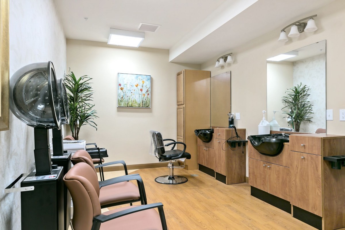 A well-organized salon interior featuring chairs, mirrors, and washing stations.