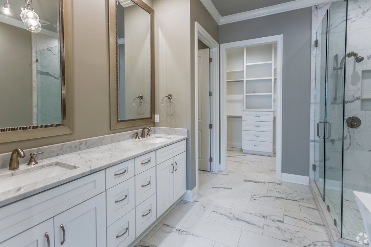 Modern bathroom with a dual-sink vanity and ample storage space.