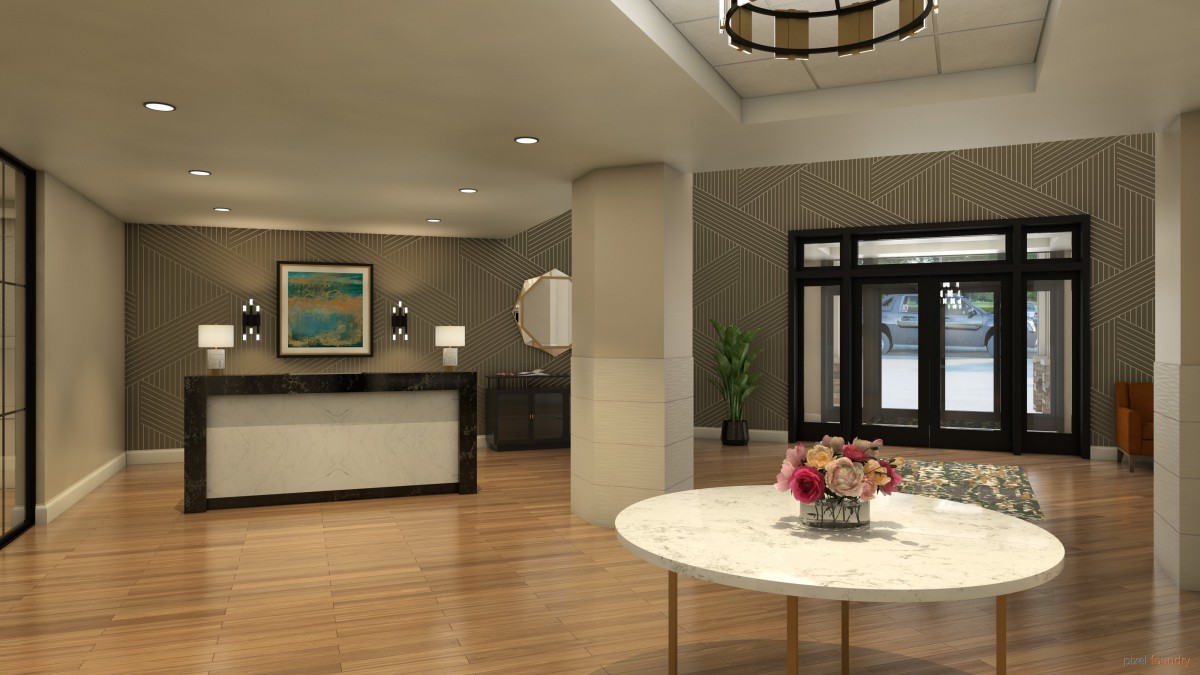 A modern lobby with a reception desk, elegant decor, and a round table with flowers.