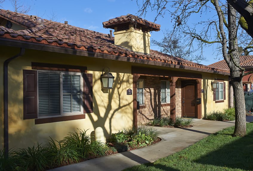 A Spanish-style residential house with a tiled roof and well-maintained landscaping.