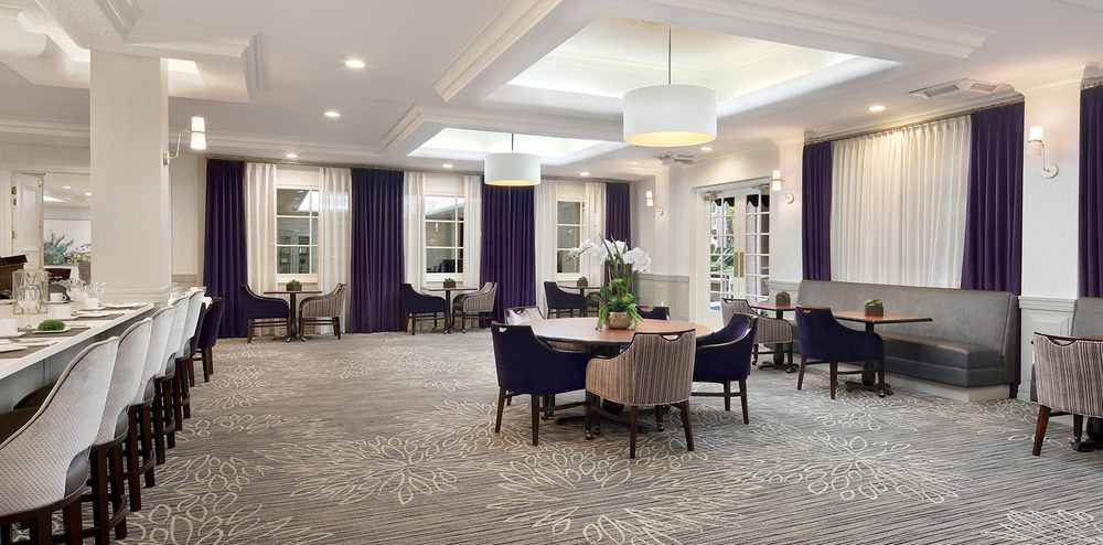 A modern dining room with elegant decor and ample natural light.