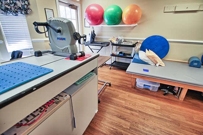 A physical therapy room equipped with exercise balls and rehabilitation equipment.