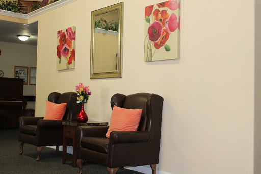 A cozy seating area featuring decorative art and flowers.