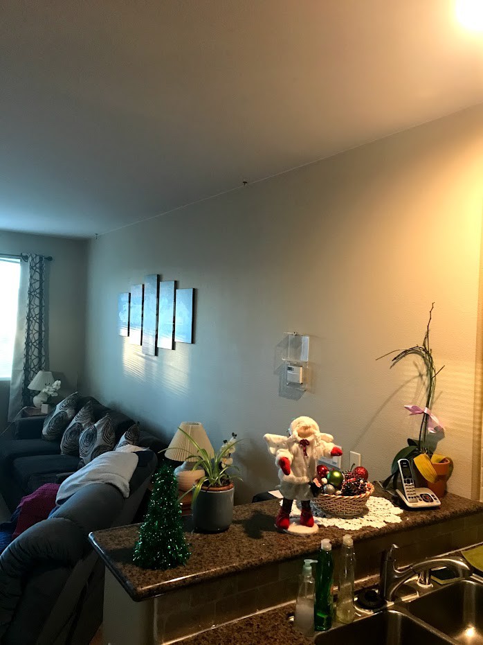A cozy living room with a sofa, decorative elements, and ambient lighting.