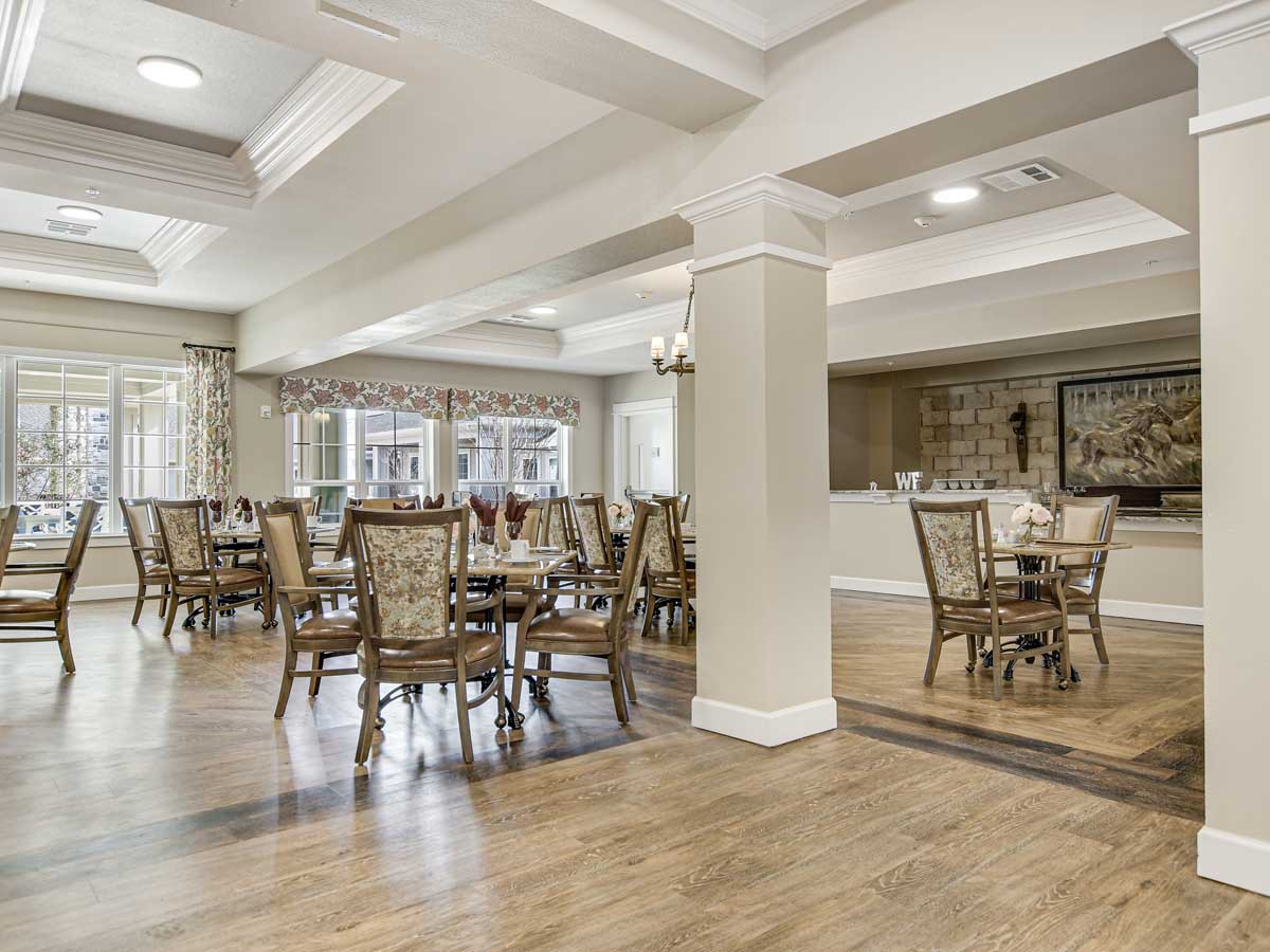 A spacious dining area with elegant furnishings and natural lighting.
