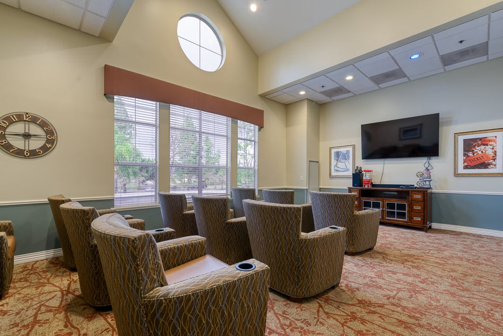 A comfortable lounge area with ample seating and a large television.