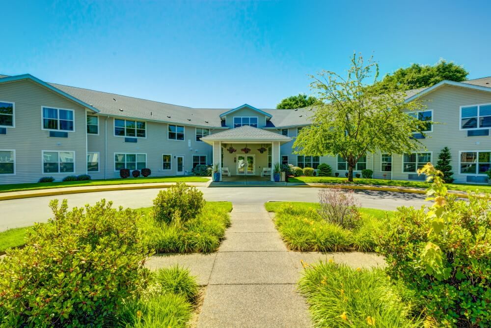 A residential building with a landscaped entrance and pathway.
