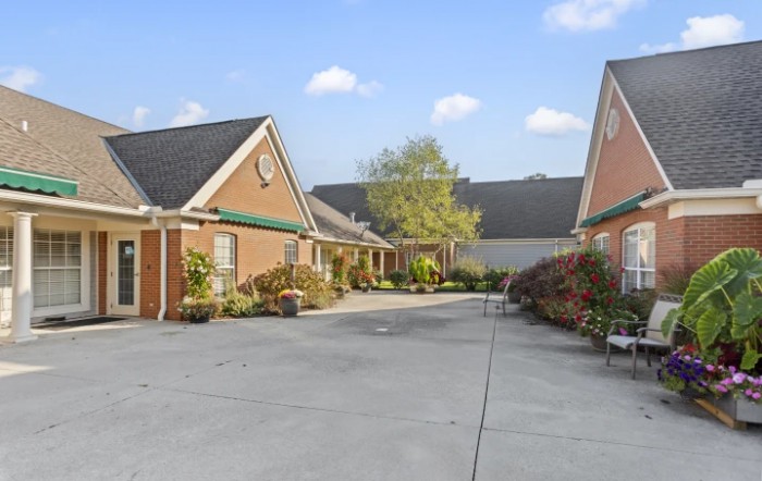A suburban residential area with houses lined along a driveway on a clear day.