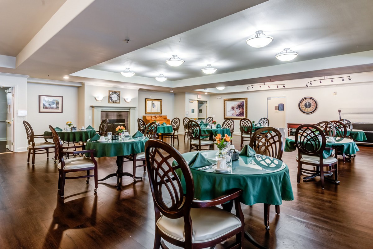 An elegant dining area with neatly arranged tables and chairs, featuring a warm and inviting interior design.