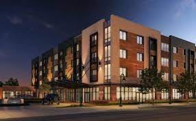 A modern multi-story building illuminated at night.