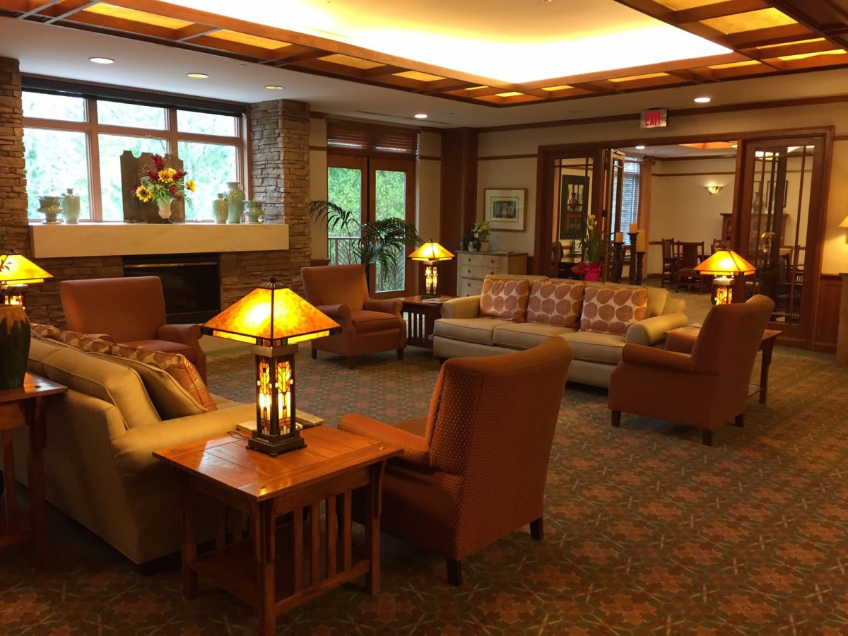A cozy lobby area featuring comfortable sofas, armchairs, and warm lighting.