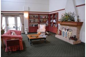 A cozy living room with bookshelves and a fireplace.
