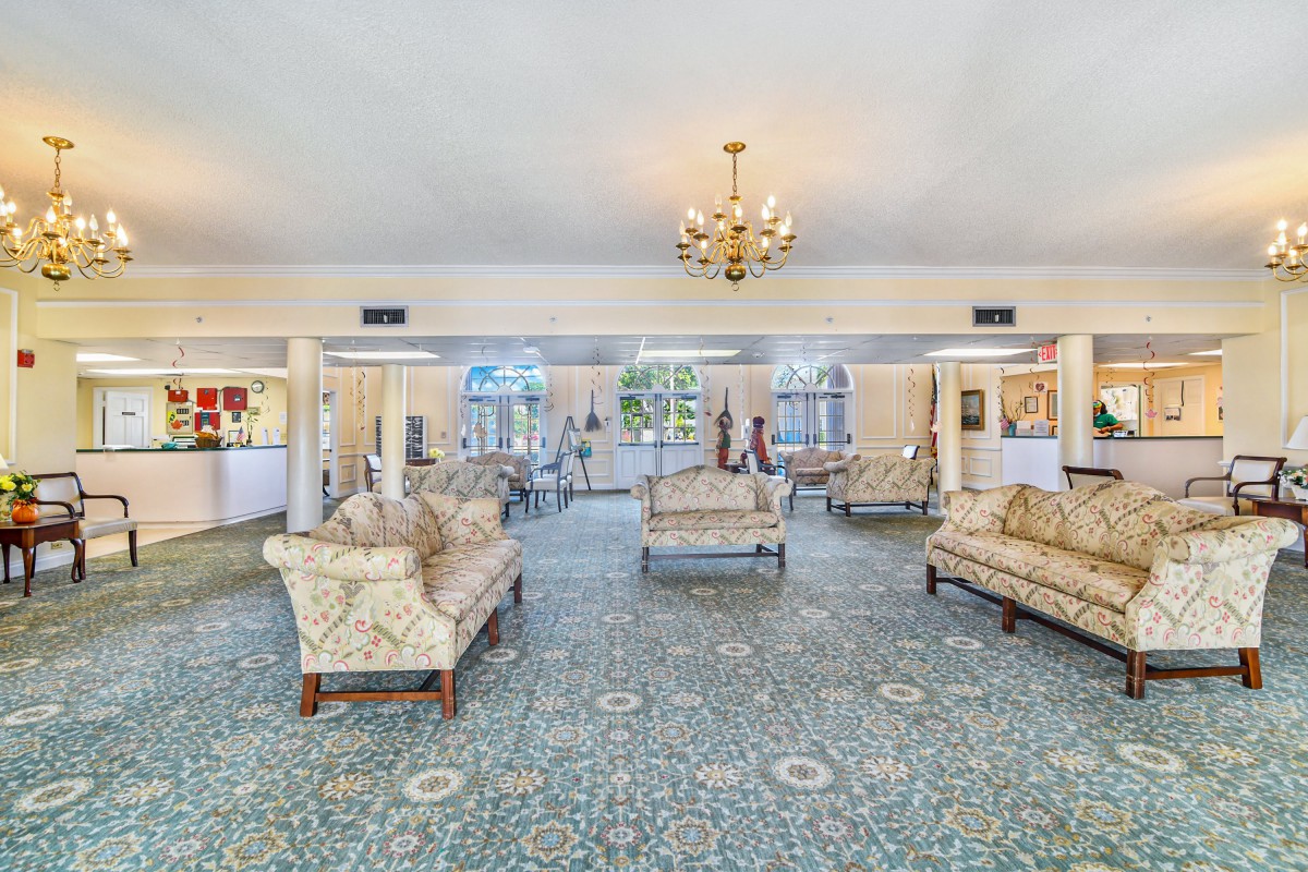 Elegant hotel lobby with classic sofas and a chandelier.