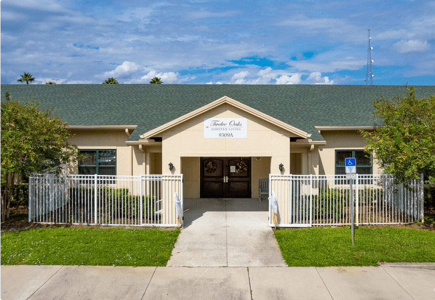The entrance to a daycare center with a green roof and fenced walkway.