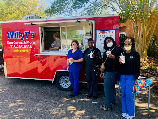A group of friends enjoying drinks from a food truck on a sunny day.