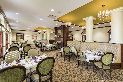 An elegant dining area showcasing an inviting atmosphere with carefully arranged tables and luxurious furnishings.