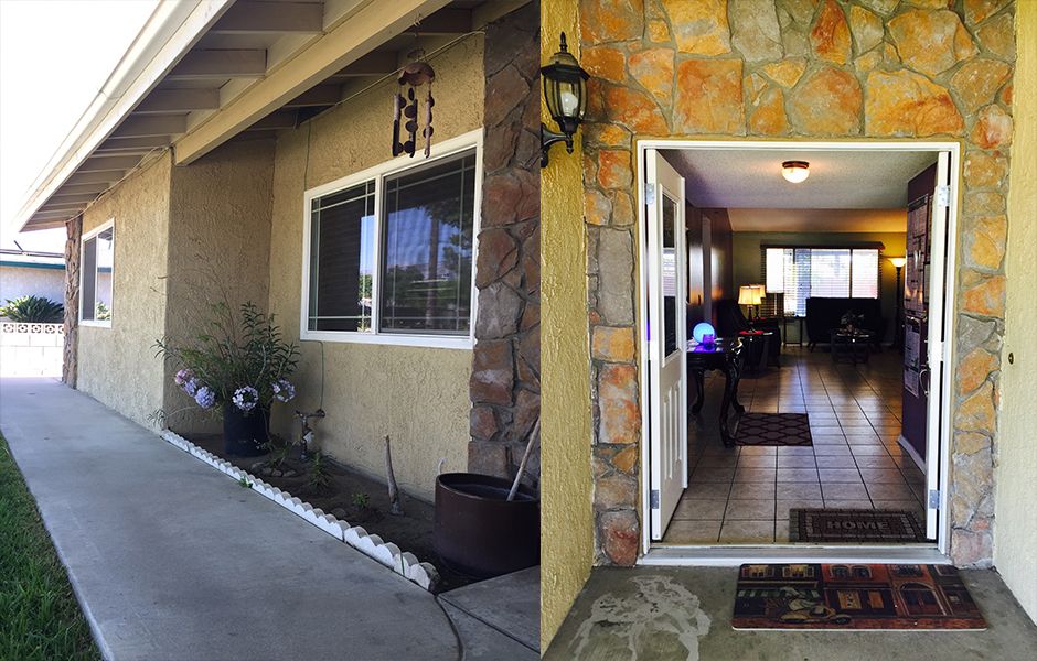 An inviting house entrance with an open front door and stone accents.