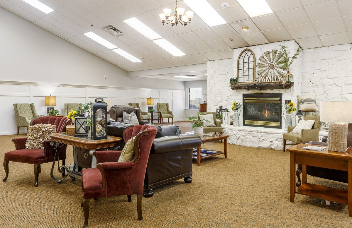 A cozy living room with comfortable seating and a fireplace.