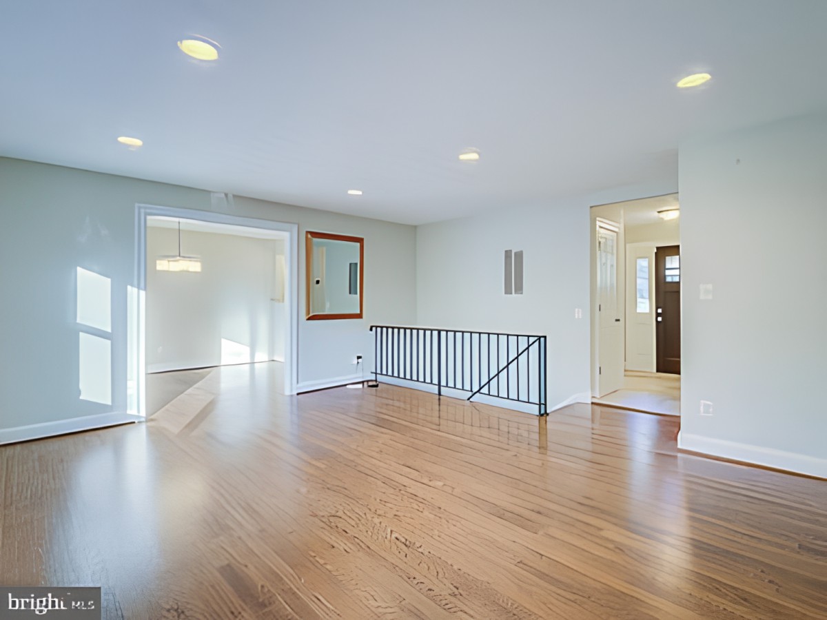 A bright and open living room with hardwood flooring and modern decor.