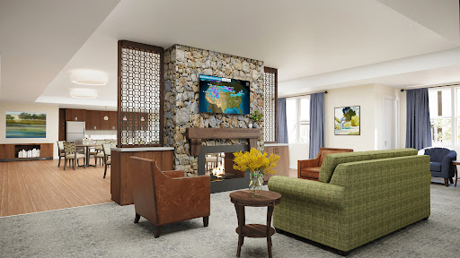 A cozy and modern living room featuring a stone fireplace, comfortable seating, and artistic decorations.