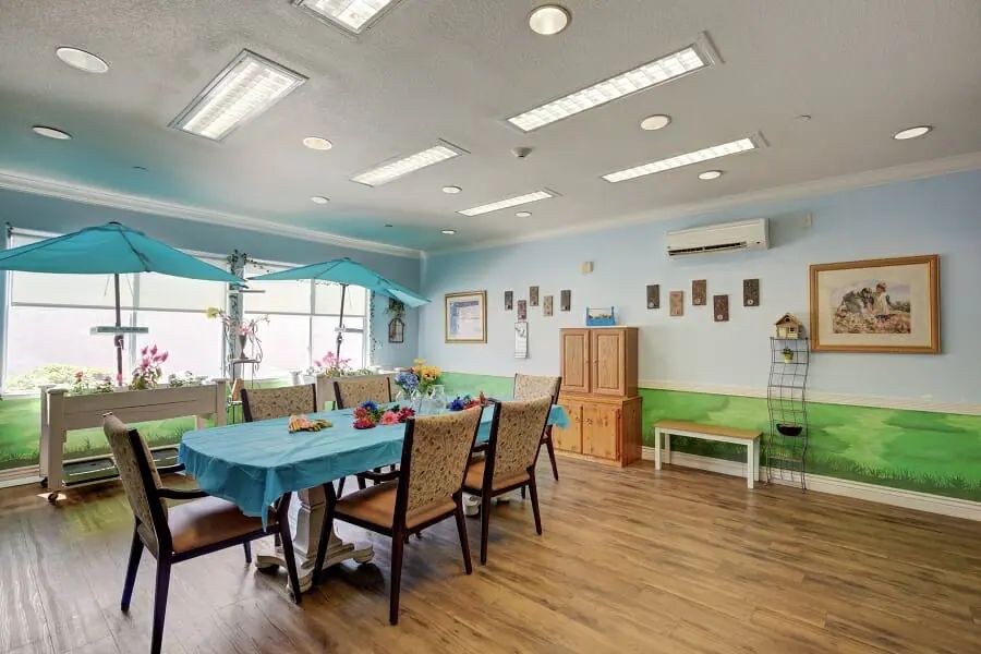 A cozy and well-lit dining area with tables and chairs, decorated with a homey touch.