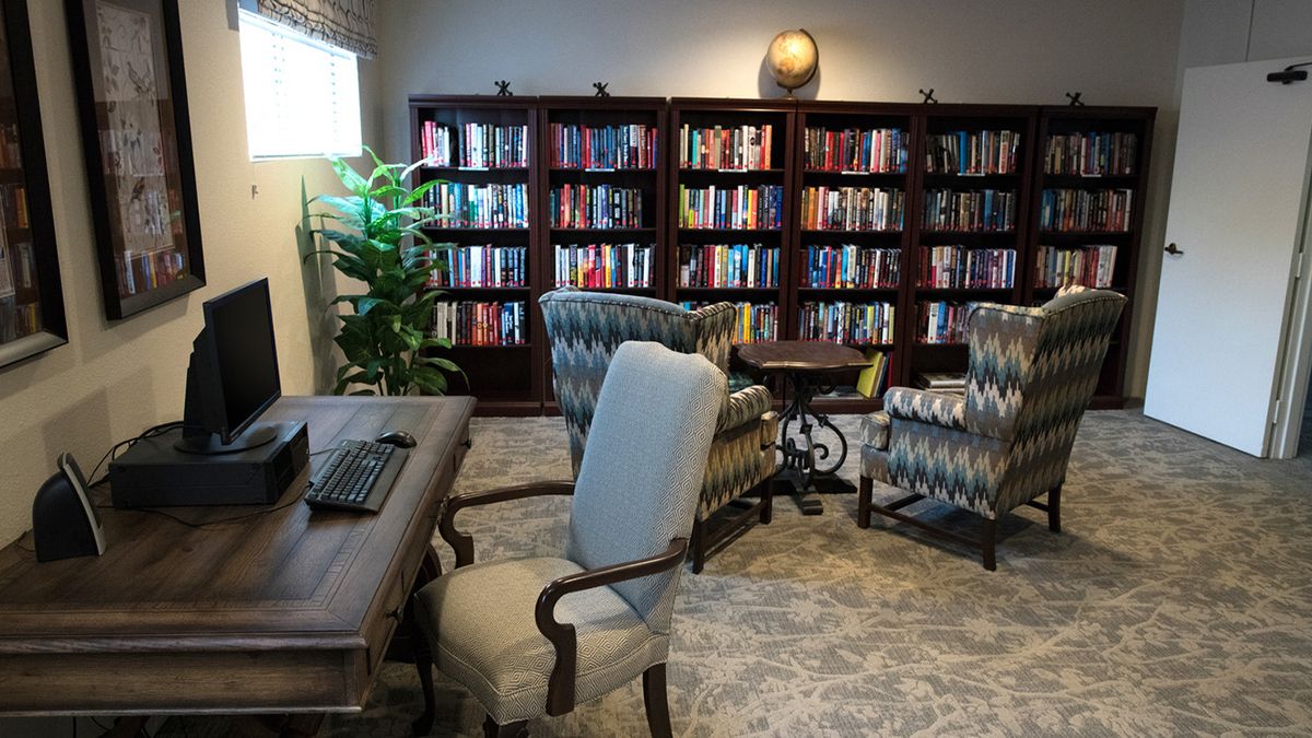 A cozy library with bookshelves and comfortable seating for reading.
