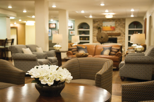 A cozy and modern living room with stylish furniture and a floral centerpiece.