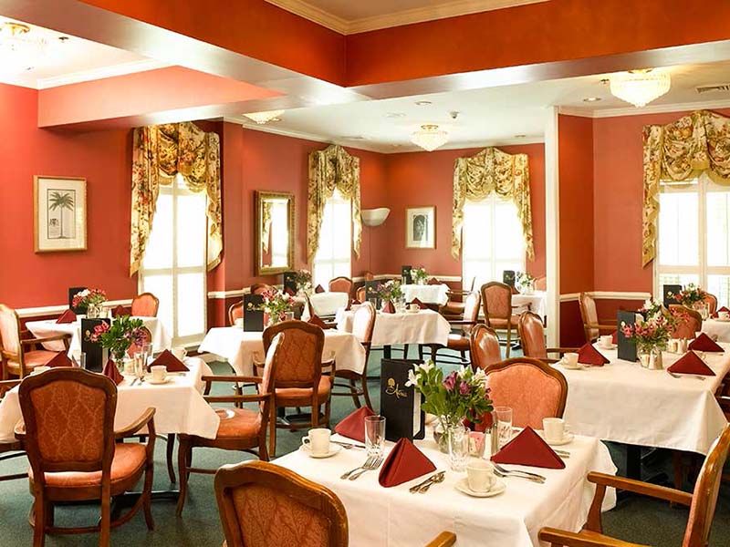 An elegant restaurant dining room with beautifully set tables and stylish decor.