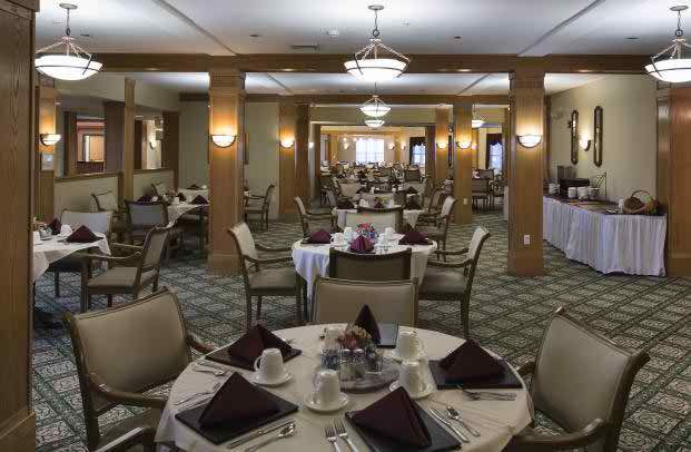 A spacious dining room with neatly arranged tables and chairs, ready for guests.