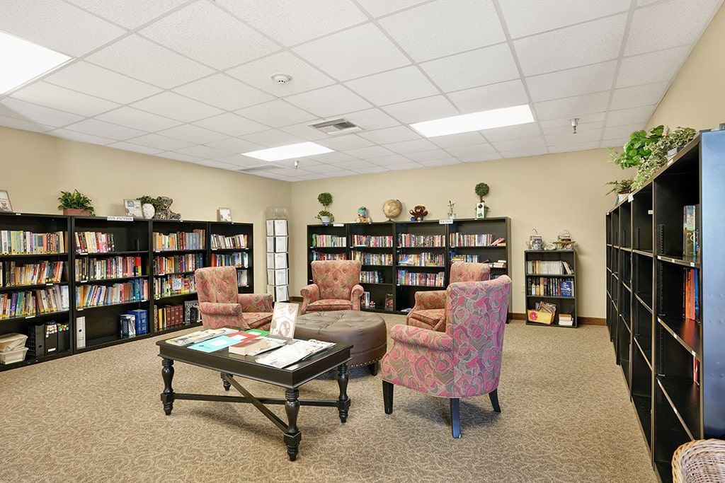 A cozy reading area with bookshelves and comfortable chairs.