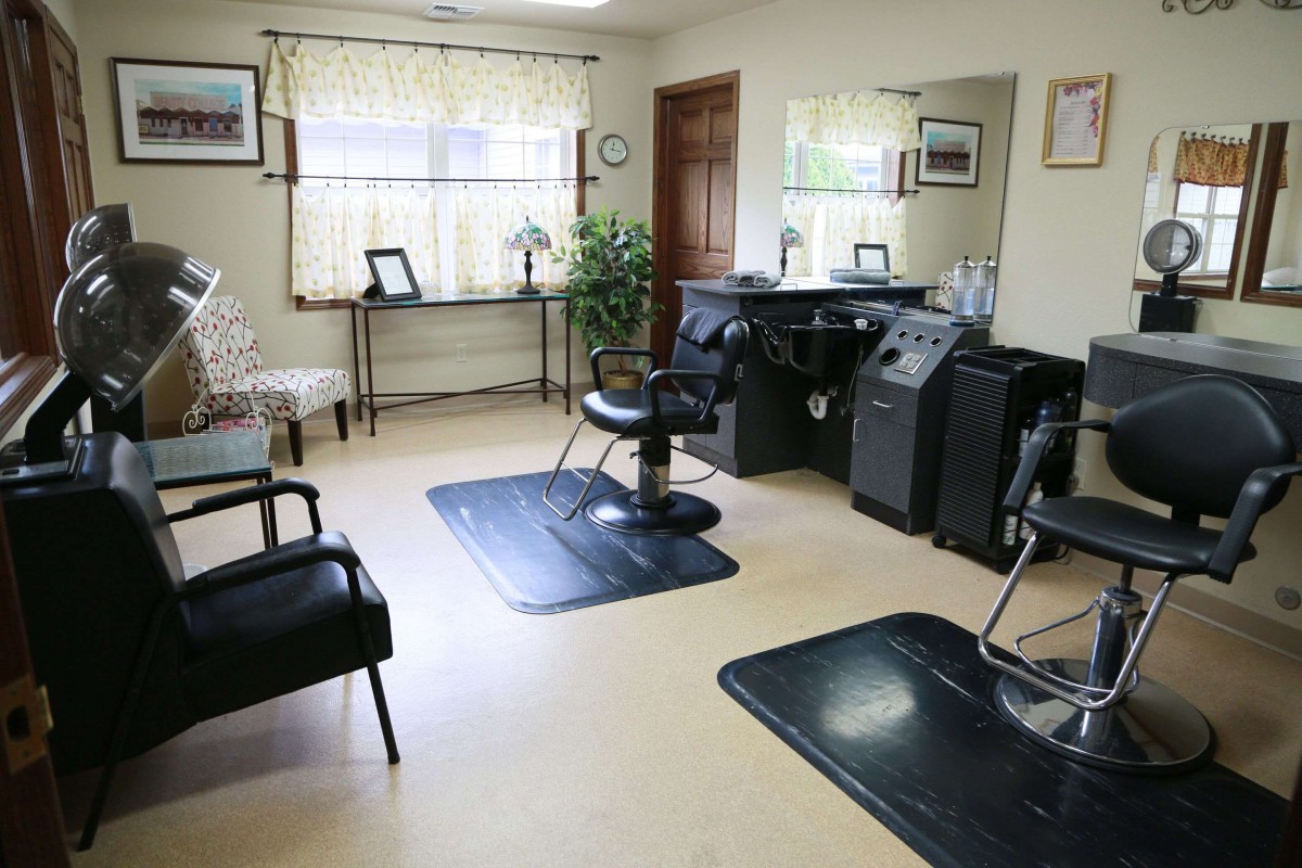 Interior of a hair salon with chairs, mirrors, and a sink.