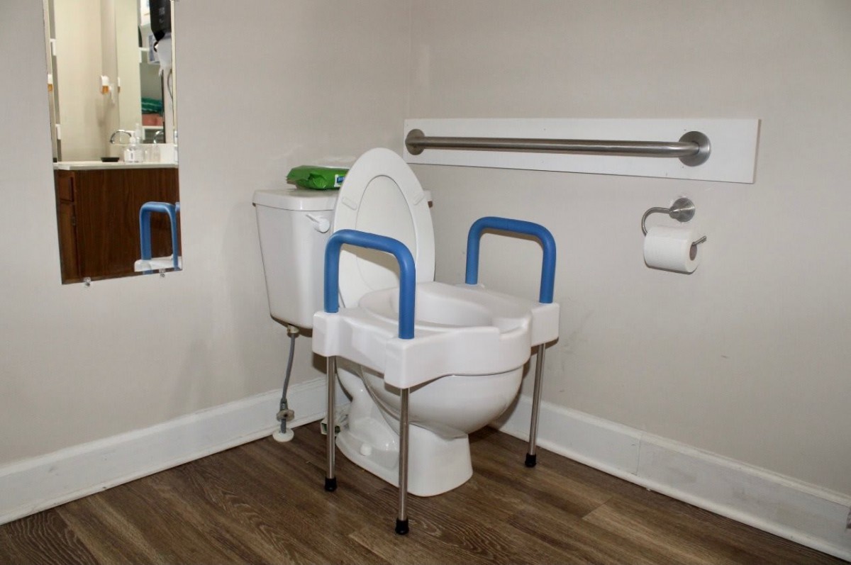 An accessible bathroom with supportive handrails and safety features.