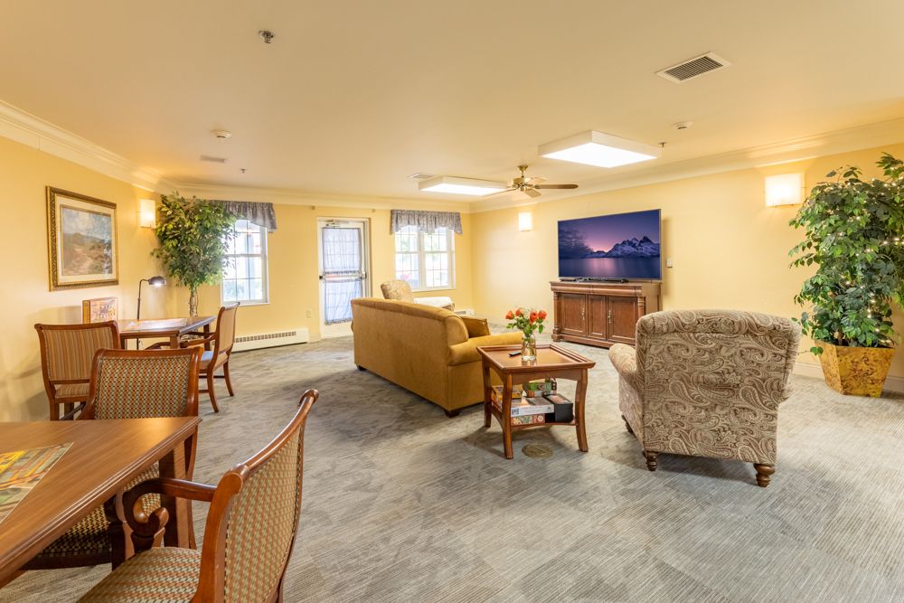 A cozy living room with comfortable seating and a large television.