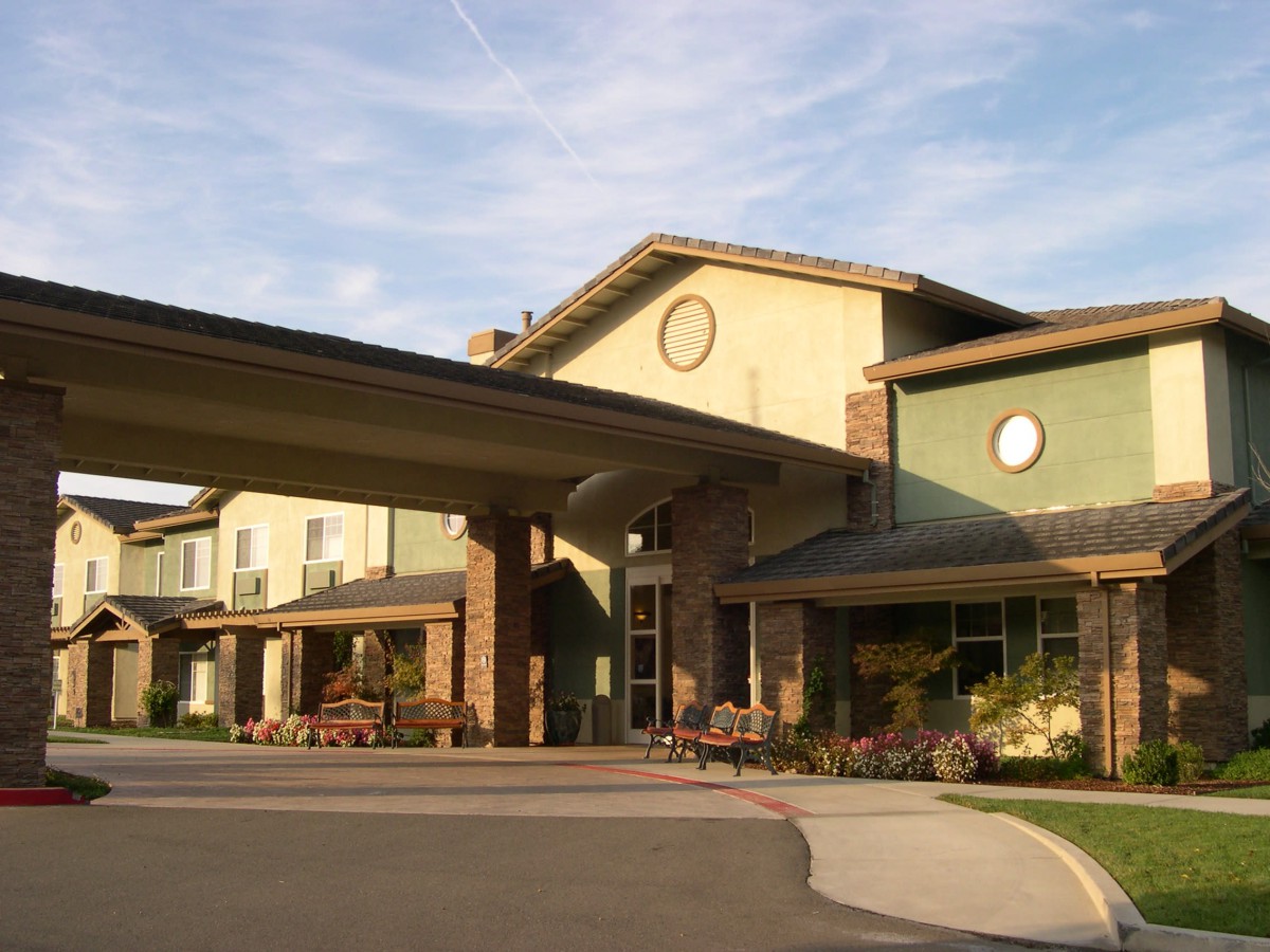 The exterior view of a modern building with a large entrance and covered walkway.