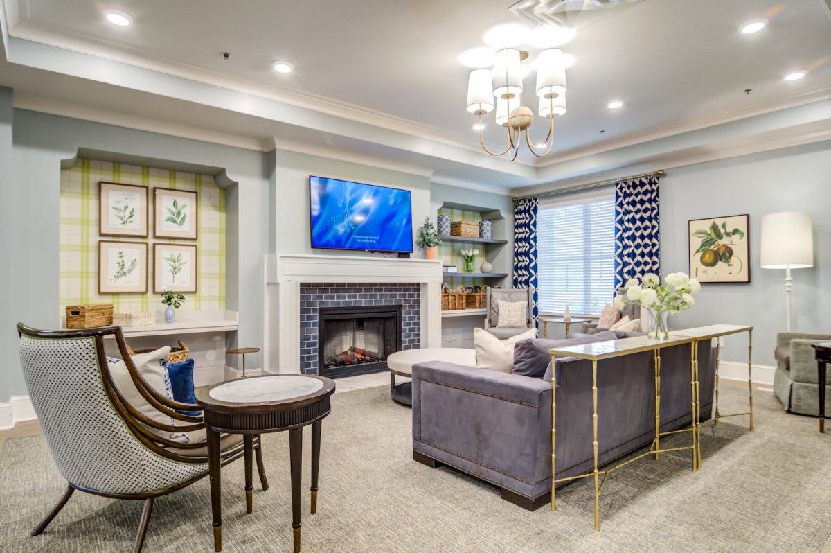 A stylish and modern living room with a cozy atmosphere, featuring a fireplace and a mounted television.