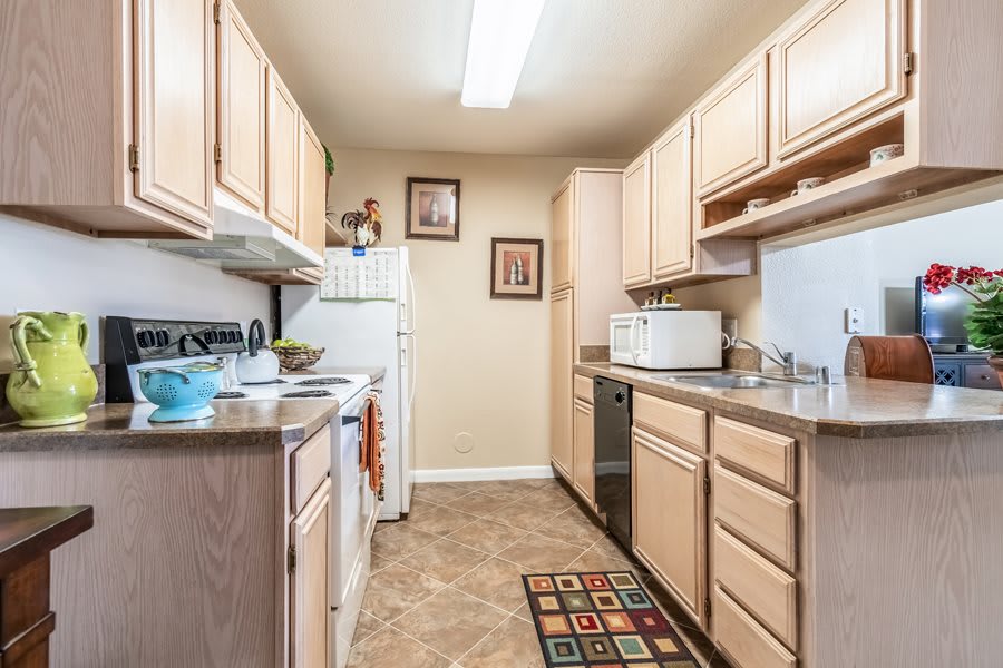 A well-organized kitchen with wooden cabinets and modern appliances.