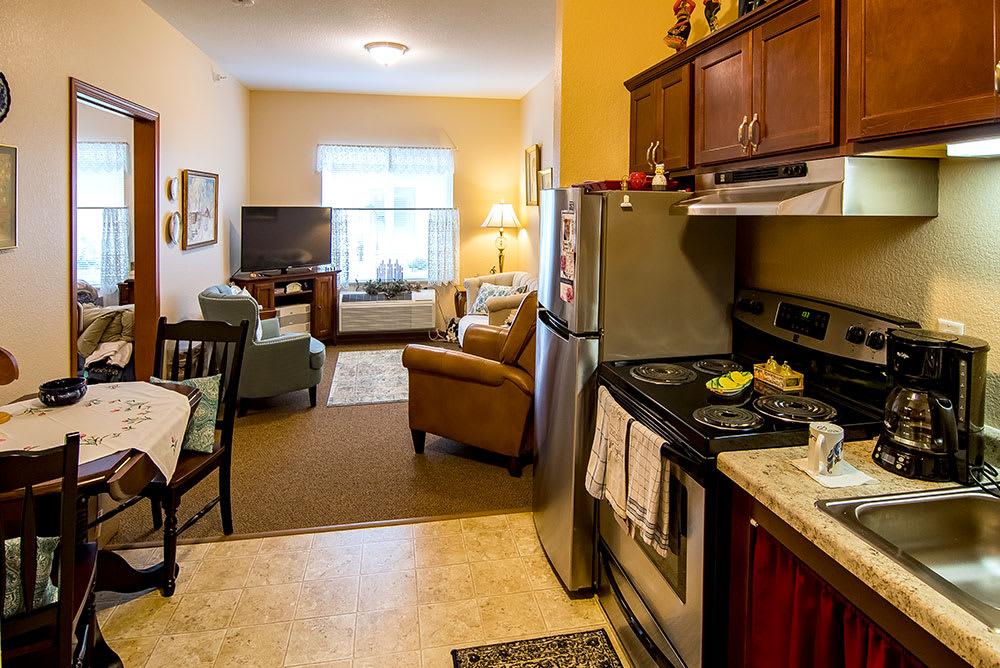 A cozy apartment with an open kitchen and living room area.